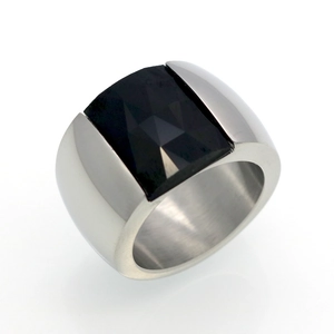 Macro view of wide silver steel ring band featuring a faceted square black gemstone