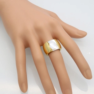 Detailed view of a wide gold titanium steel ring with a large rectangular clear crystal