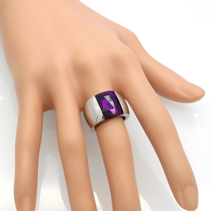 Close-up of a wide silver titanium ring with a large rectangular purple gemstone