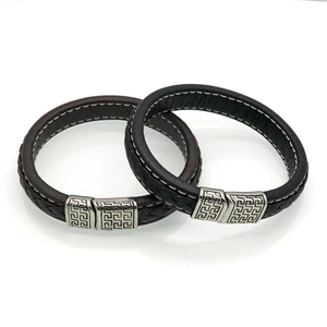 Detail of men's leather bracelets with stainless steel clasps and Greek key patterns