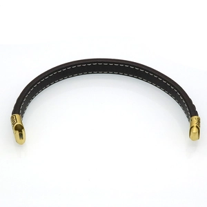 Close-up of brown leather men's bracelet with gold greca pattern steel clasp