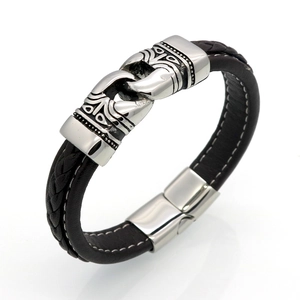 Macro detail of men's leather bracelet with vintage embossed stainless steel clasp