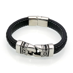 Close-up of men's leather bracelet with tribal totem metal charms and magnetic clasp