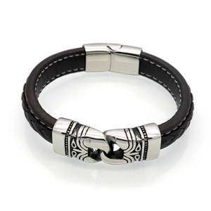 Macro view of brown leather men's bracelet with intricate woven texture and metal clasp