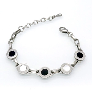Detailed macro view of silver titanium bracelet with Roman numerals and shell inlays
