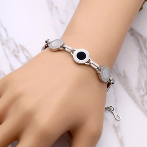 Titanium steel bracelet with Roman numerals and black-white shell inlays on wrist