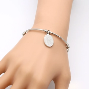 Silver stainless steel beaded bracelet with oval religious Virgin Mary pendant on wrist