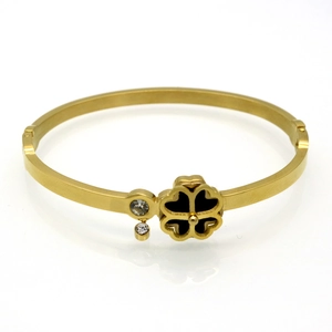 Detailed view of 18K gold-plated clover bangle with inset sparkling white zircon accents