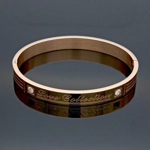 Rose gold stainless steel bangle with Love Collection engraving and cubic zirconia stones