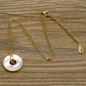 Detail of 18KGP stamp on adjustable lobster clasp of gold mother of pearl necklace