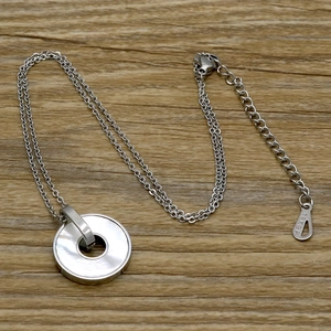 Detailed macro view of 18KGP engraving on the lobster clasp and extension chain