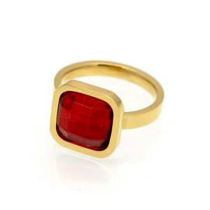 Macro detail of square faceted red zircon gemstone set in a sleek gold plated ring band