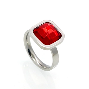 Close-up of a silver ring featuring a large square red faceted crystal in a bezel setting