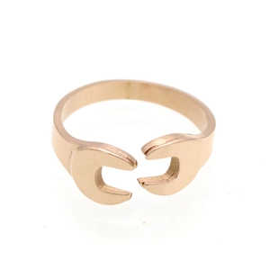 Detailed view of rose gold wrench-style open ring with brushed metal texture finish
