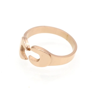 Close-up of rose gold wrench-style open ring with a polished metal finish for couples