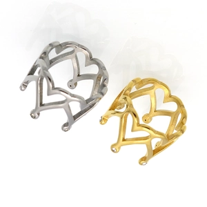 Detail of gold and silver heart crown rings with small zircon stones and open band