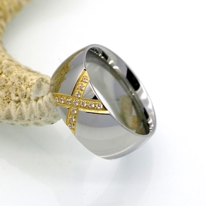 Titanium steel X-shaped ring with inlaid zircon stones on a white starfish background