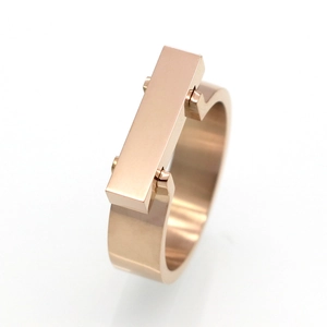 Macro shot of rose gold square geometric ring with polished industrial metal texture