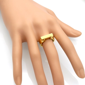 Minimalist square polished gold titanium steel ring shown on finger with mirror reflection