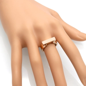 Detail of rose gold square stainless steel ring showing side hinge structure and finish