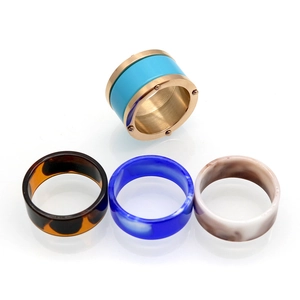 Set of four rings featuring a gold metal band with turquoise enamel and resin textures
