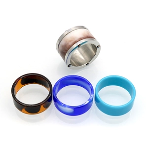 Detail of four resin interchangeable rings showing tortoise shell and marble textures