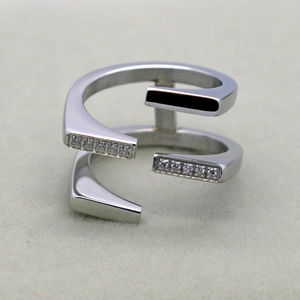 Macro detail of silver layered ring with pavé cubic zirconia and black enamel inlay