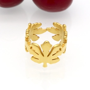 Golden hollowed maple leaf open ring made of stainless steel on white background