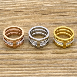 Close-up of triple-layered 18k gold plated rings with crystal pavé and vertical bars