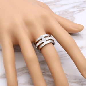 Detailed view of triple-layer silver-toned ring with pavé-set sparkling zircon stones