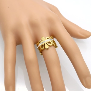 Elegant gold crown ring with hollowed-out wave design and inlaid crystals on hand model