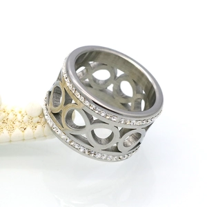 Macro detail of silver steel ring with hollow infinity symbols and double-row crystal pave