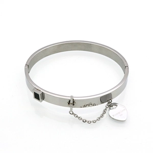Detail of silver stainless steel bangle with hinge clasp and Forever Love heart charm