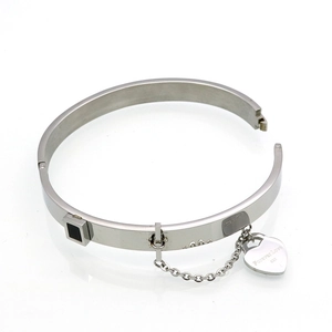 Detail of silver heart charm with Forever Love engraving on a black stone bangle