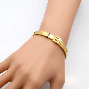 Golden stainless steel rivet belt buckle bangle for women in a 45-degree angle view
