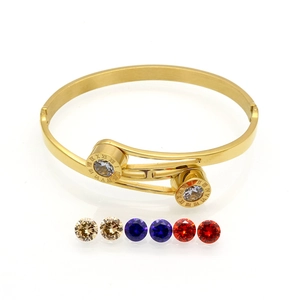 Detail of gold roman numeral bangle showing colorful cubic zirconia interchangeable stones
