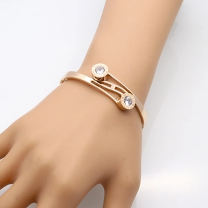 Rose gold stainless steel bangle with roman numerals and cubic zirconia inlay
