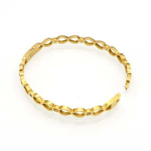Bracelet infini doré évidé avec zircons brillants présenté en position ouverte