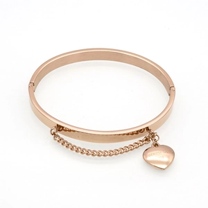 Detail of rose gold heart charm bangle with Forever Love engraving and chain link