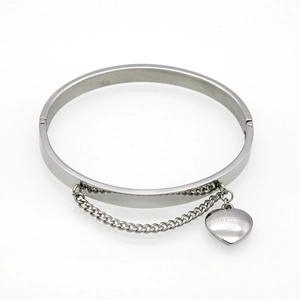 Macro shot of stainless steel heart pendant bracelet with Forever Love engraving