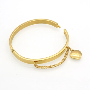 Polished gold stainless steel bangle with heart charm and Forever Love engraving