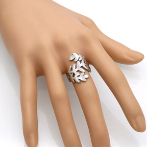 Minimalist silver branch and leaf open ring in stainless steel shown on a hand model