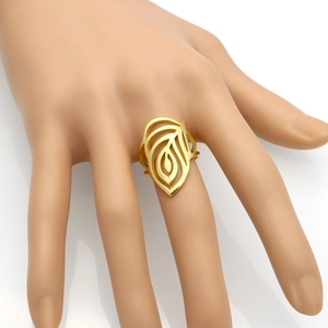 Bague feuille évidée en acier inoxydable doré portée à la main sur fond blanc