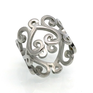 Detail of silver hollowed scroll pattern ring with polished vintage metallic finish