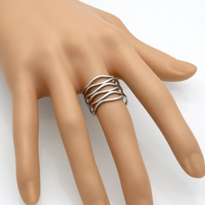 Detailed view of silver titanium steel wavy multilayer ring worn on a model hand