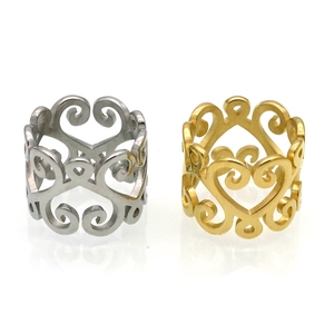 Set of gold and silver hollow heart rings with vintage scroll patterns on white background