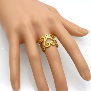 Gold hollow filigree heart ring in vintage bohemian style displayed on model hand