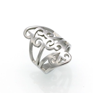 Detailed view of silver hollow-out shield ring featuring intricate scrollwork textures