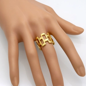 Modern gold rectangular hollow geometric ring shown on hand with a sleek wide band design