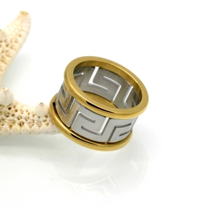Two-tone gold and silver stainless steel ring featuring cutout Greek key meander pattern